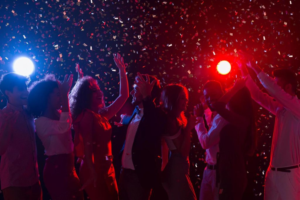 New year's eve party. happy crowd dancing at nightclub, copy space